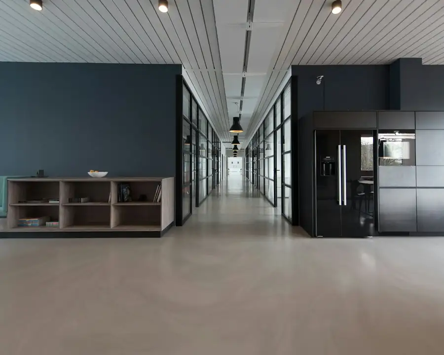 An office lobby with seating along a bright hallway